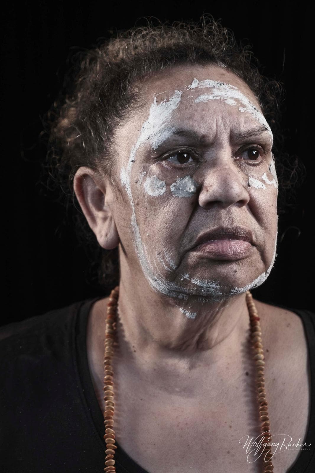Portrait of a Giinagay community elder with traditional body paint