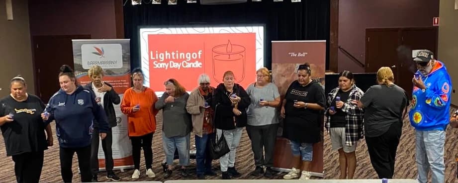 Community members gathered in front of a lighting event display